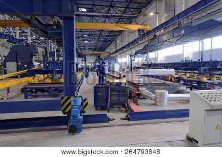 ST. PETERSBURG, RUSSIA - JUNE 30, 2015: Worker at work in the Megapolis plant owned by Amira Group. It's Russia's largest plant producing the lighting poles