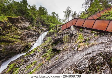 Staircase To Walk Up To Svandalsfossen In Norway, Waterfall In Norwegian Mountains. National Tourist