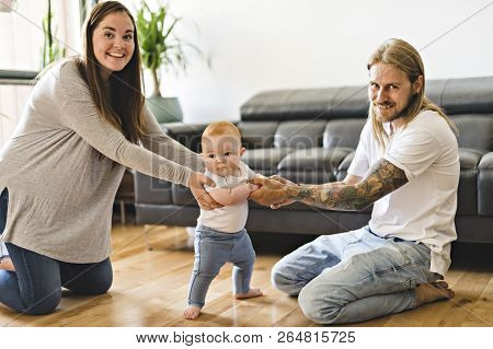 Parent Help Baby Daughter Take First Steps At Home