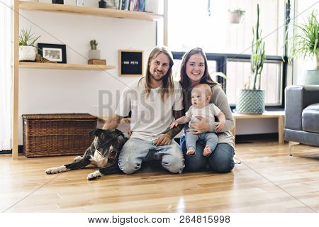 Beautiful Little Girl And Her Parent Getting Some Puppy Love On The Living Room