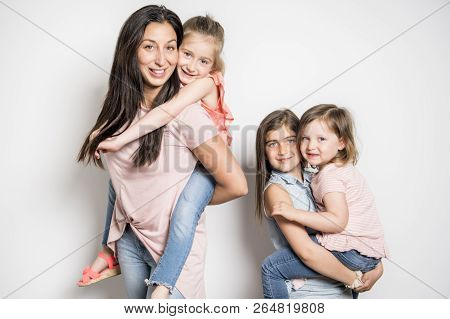 Caucassian Mother With Child Girl In Studio White