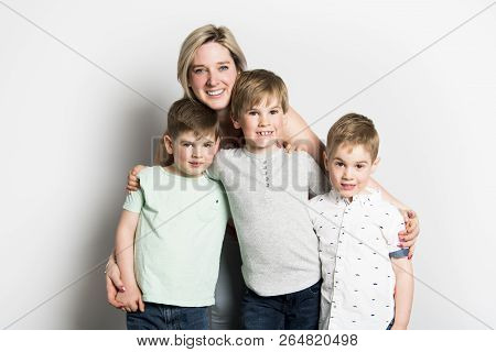 Caucassian Mother With Child Boy On Studio White