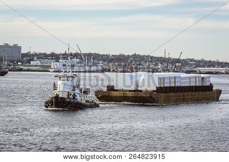 New Bedford, Massachusetts, Usa - February 26, 2018: Tug Sirius Towing Barge Of Wrapped Modules Out 