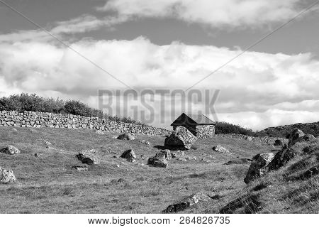 Farmhouse In Torshavn, Denmark. Old Stone House In Farm Yard On Cloudy Blue Sky. Typical Rural Archi