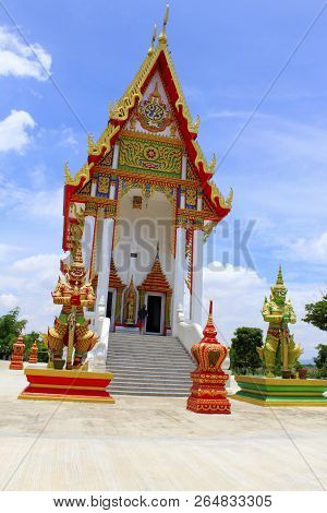 Front View Of The Red And White Temple With The Guards And Steps Leading To The Main Idol Inside At 