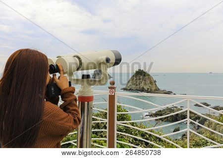 Binoculars. Young Girl Use Binocular Looking To The Island View At Oryukdo Islands In Busan, South K