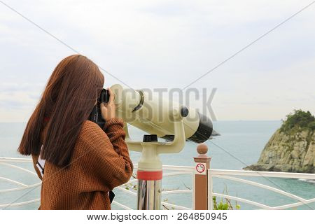 Binoculars. Young Girl Use Binocular Looking To The Island View At Oryukdo Islands In Busan, South K