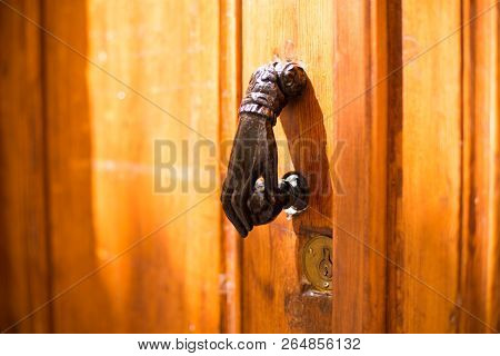 Close-up. Vintage Handle For Knocking On The Door In The Form Of A Hand.