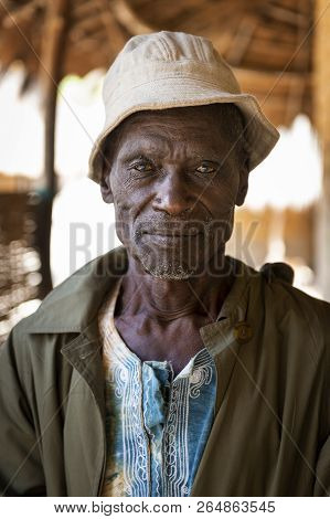 Orango Island, Guinea-bissau - February 3, 2018: Portrait Of An Old Man In Front Of His House At The