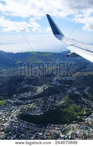 Aerial View Of The Suburb Of Karori, Wellington With Makara Wind Farm In The Background