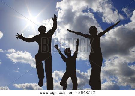 Happy Family Silhouette On Sunny Sky