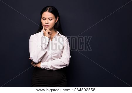 Thouhgtful Business Woman With Long Dark Hair Looking Aside. Having Business Problems.