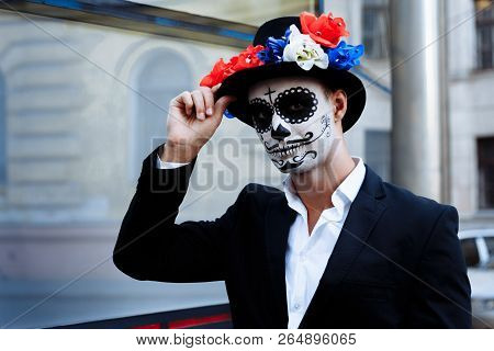 A Man With A Painted Face Of A Skeleton, A Dead Zombie, In The City During The Day. Day Of All Souls