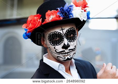 A Man With A Painted Face Of A Skeleton, A Dead Zombie, In The City During The Day. Day Of All Souls