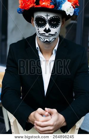 A Man With A Painted Face Of A Skeleton, A Dead Zombie, In The City During The Day. Day Of All Souls