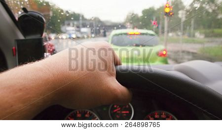 Closeup Of Hand Holding Steering Wheel During Driving A Car In Rainy Weather. Pov Shot, Point Of Vie