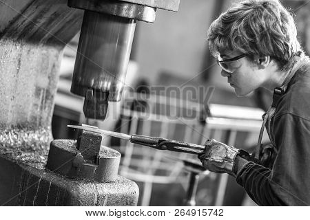 Young Blaksmith Working With Hot Metal In A Workshop