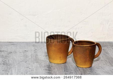 Handmade Coffee Clay Cups On A Dark Concrete Background And A White Concrete Wall.