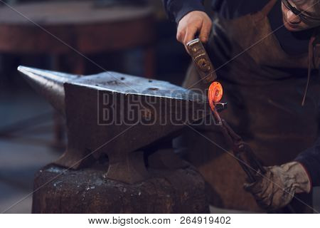 Metalworker Forming A Coil With Hot Metal
