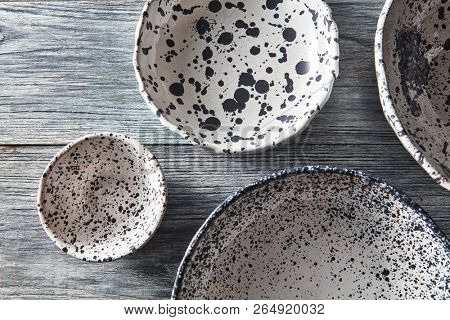 Traditional glay vintage handmade dishes. Flat lay. Set of porcelain blue bowls on a gray concrete table with copy space.