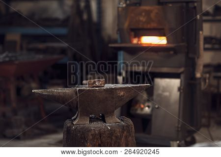 Mallet On An Anvil In Front Of A Furnace
