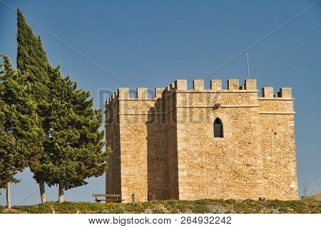 A Small Spainsh Castle On Top Of A Hill In The Evening Light.