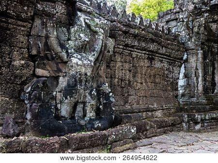 Ancient Carved Mural Garuda Catching Nagu On The External Fencing Of The Preah Khan Temple At Angkor