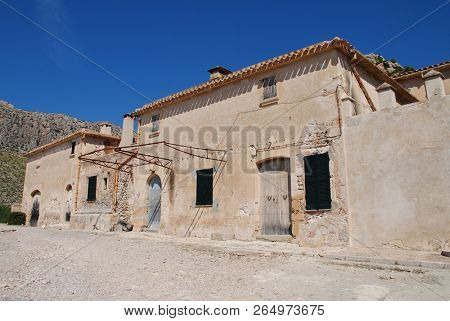 MAJORCA, SPAIN - SEPTEMBER 30, 2018: The old farm buildings at the entrance to the Boquer valley walk in Puerto Pollensa. The 3km trail leads though the Tramuntana mountains to Cala de Boquer.