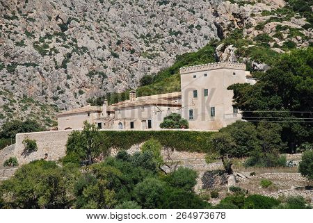 MAJORCA, SPAIN - SEPTEMBER 30, 2018: The old farm buildings at the entrance to the Boquer valley walk in Puerto Pollensa. The 3km trail leads though the Tramuntana mountains to Cala de Boquer.