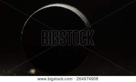 Medical Drug, Black Tablet Activated Carbon On A Black Background In Backlight