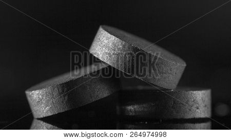 Medical Drug, Black Tablet Activated Carbon On A Black Background In Backlight