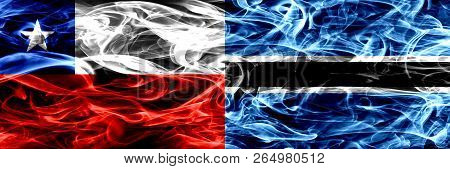 Chile, Chilean Vs Botswana, Botswanan Smoke Flags Placed Side By Side. Concept And Idea Flags Mix
