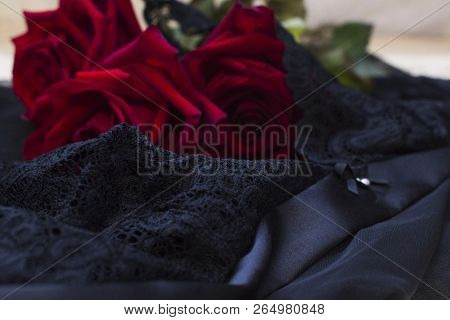 Red Roses On A Black Lace Lingerie