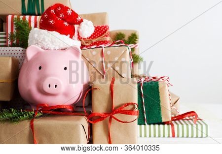 Piggy Bank And A Lot Of Gift Boxes. Christmas Decor. White Background. Fir Branches.