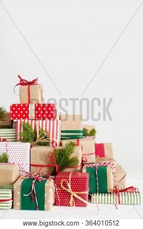 Big Mountain And Lots Of Christmas Gifts. Red, Green And Beige From Kraft Paper.