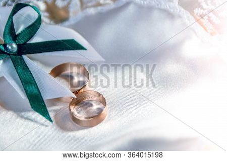 Wedding Rings On A White Tray With A Bow. Preparing For The Wedding.