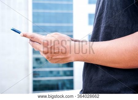 Young Asian Or  Indian Man Using Smartphone