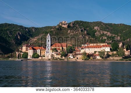 Duernstein Cityscape With Blue And White Baroque Abbey Church Tower And Kuenringer Castle, Located O