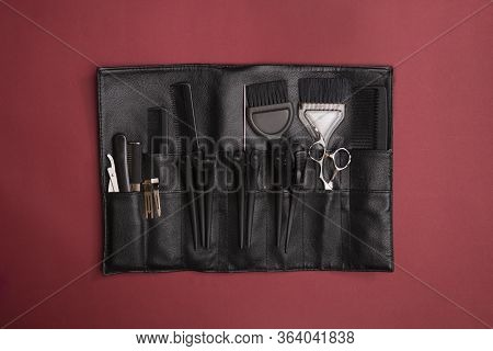 A Set Of Scissors For Cutting Hair For A Professional Hairdresser. On A Red Background
