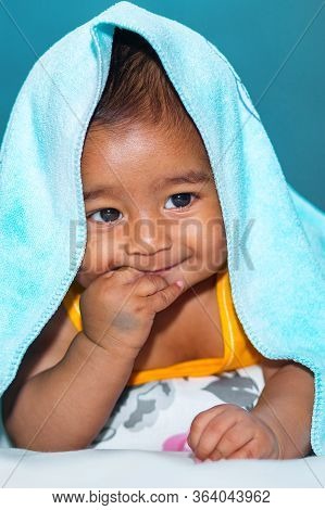 A Six Months Age Asian Baby Boy Playing A Yellow Taddy Bear.