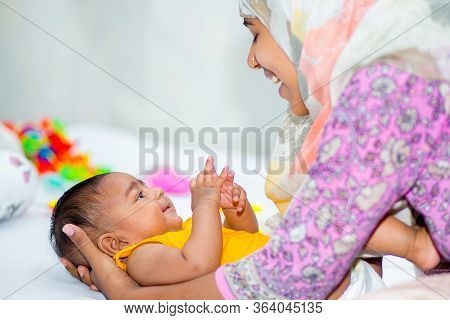 A Mother And A Six Month Age Baby Boy Enjoying Their Time.