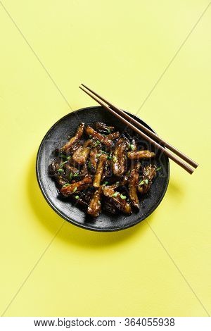 Stir-fry Bulgogi Eggplant On Plate Over Yellow Background With Freee Text Space. Fried Aubergine In 