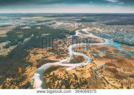 Belarus, Europe. Aerial View Curved River And Small Town In Early Spring Landscape. River Bends Curv