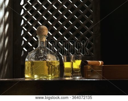 Close Up View Of Bottle Of Tequila Anejo And Cigar On Color Background