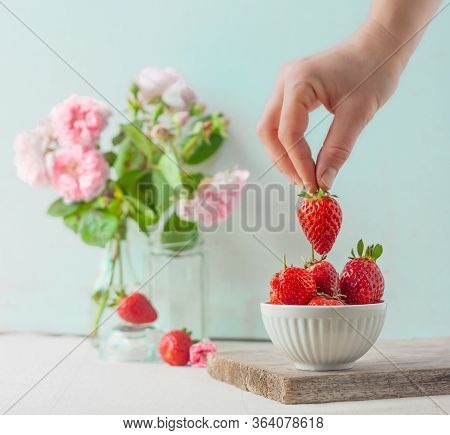 Woman Takes Or Puts One Strowberry In Fruit Bowl Full Of Fresh, Red, Jucy Strawberries. Pastel-color