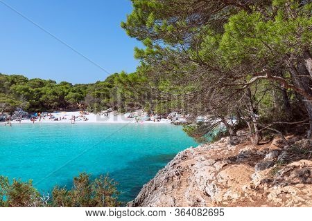 View Of The Famous Beach Cala Turqueta. (focus On Foreground, People On The Beach In Blur). Menorca,