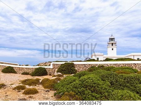 Beautiful View Of The Lighthouse (faro De Cavalleria) And The Cloudy Sky Above It. Menorca, Balearic
