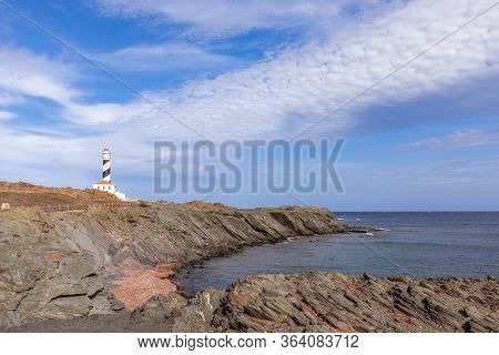 Seascape With A Quiet Sea Bay And A Lighthouse (faro De Favaritx) On The Island Of Menorca, Balearic