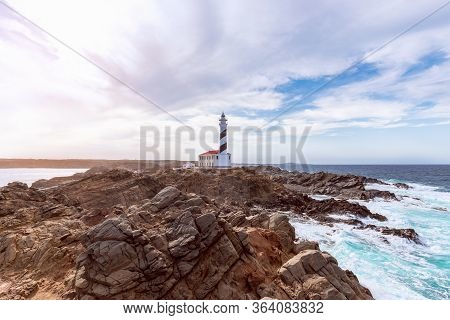 Beautiful View Of Famous Lighthouse Faro De Favaritx  Under The Sky With Clouds On The Island Of Men