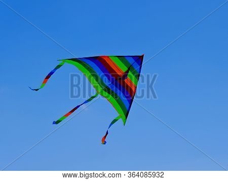Children\'s Toy. Children Fly A Flying Kite.\nbackground Image For Web Design.